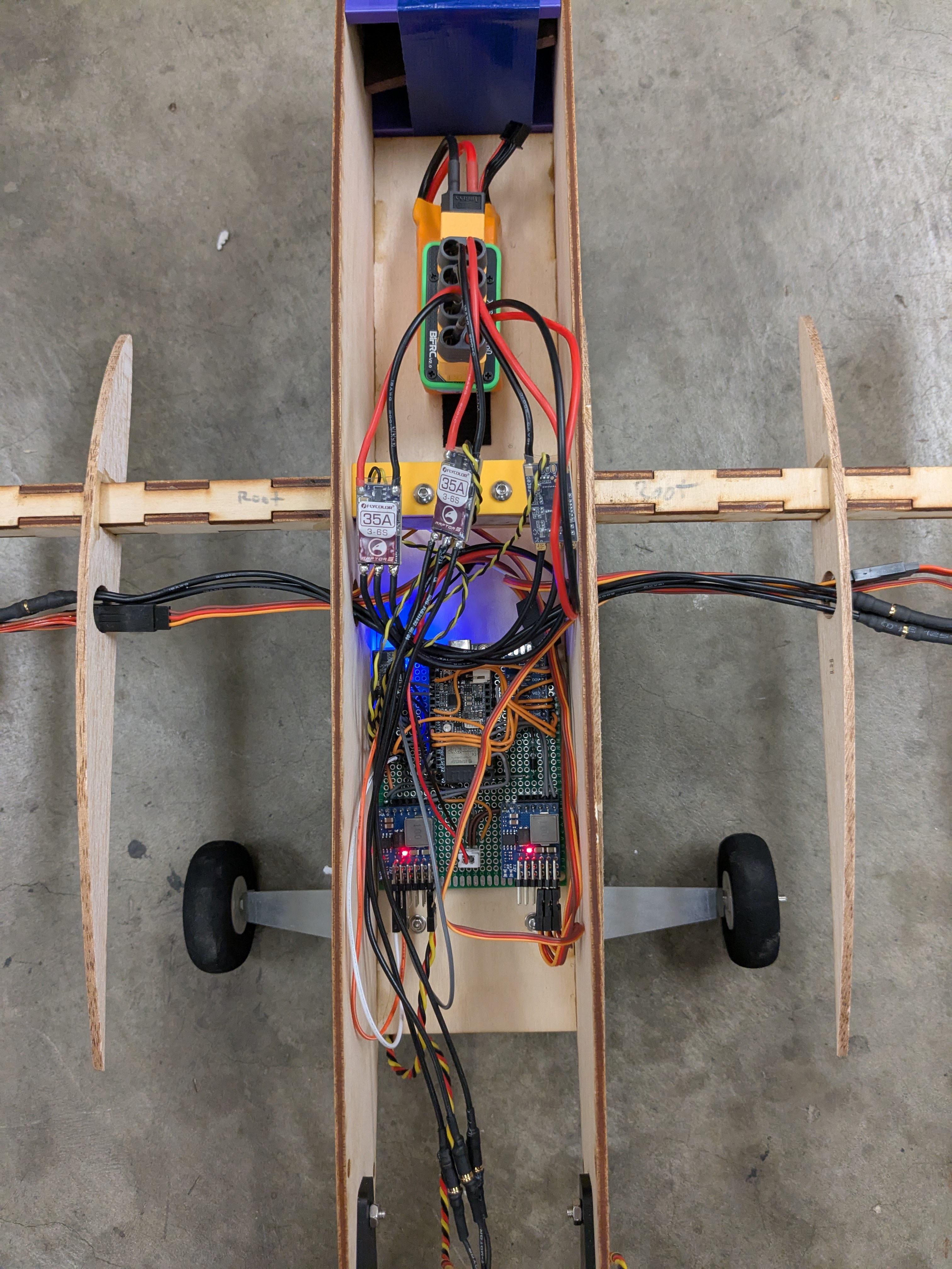 Closeup of the flight computer, wiring, and electronics mounted inside the aircraft